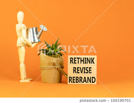 Rethink revise rebrand symbol. Concept word Rethink Revise Rebrand on beautiful block. Beautiful orange table orange background. Business brand motivational rethink revise rebrand concept. Copy space. 108190701