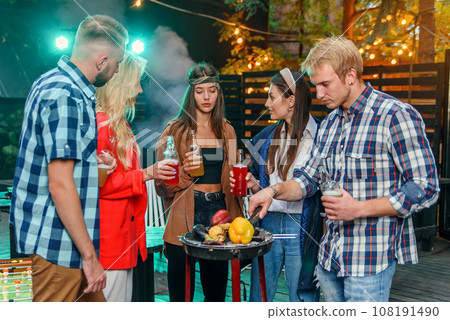 Friends having barbecue party in the backyard of the house. 108191490