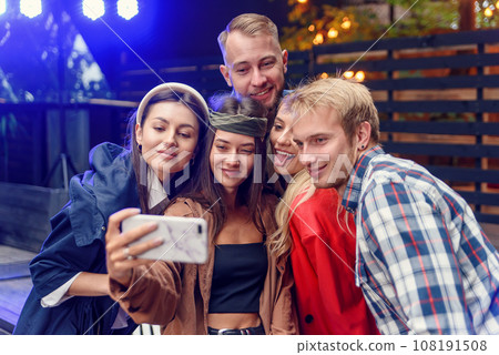 Joyful stylish friends making selfie together at the party. Everyone are smiling and and enjoying their company. 108191508