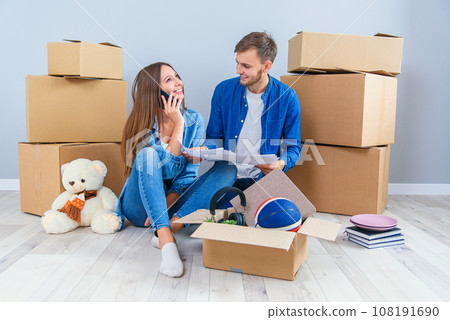 Caucasian pleasant young couple in love looking at the visualisation of their home interior design. Caucasian pleasant young couple in love looking at the visualisation of their home interior design. 108191690