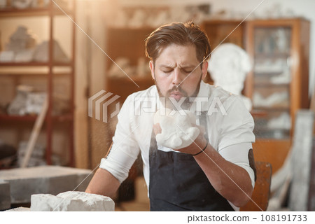 Craftsman hands working with stone sculptor at creative workplace in the atmospheric studio. Craftsman hands working with stone sculptor at creative workplace in the atmospheric studio. 108191733