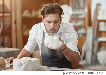 Craftsman hands working with stone sculptor at creative workplace in the atmospheric studio. Craftsman hands working with stone sculptor at creative workplace in the atmospheric studio. 108191734