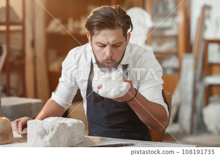 Craftsman hands working with stone sculptor at creative workplace in the atmospheric studio. Craftsman hands working with stone sculptor at creative workplace in the atmospheric studio. 108191735