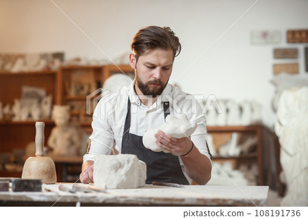 Craftsman hands working with stone sculptor at creative workplace in the atmospheric studio. Craftsman hands working with stone sculptor at creative workplace in the atmospheric studio. 108191736