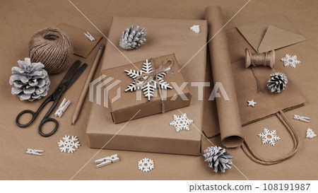 Packing Christmas gifts in brown paper 108191987