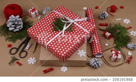 Packing Christmas gifts with red paper 108191988