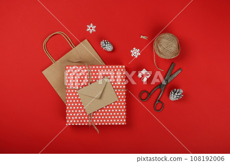 Packing Christmas gifts with red and brown paper 108192006