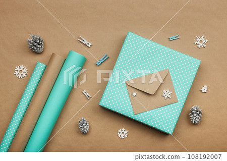 Packing Christmas gifts with blue paper 108192007