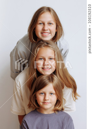 Faces of three girls in a row in casual clothes Faces of three girls in a row in casual clothes 108192810