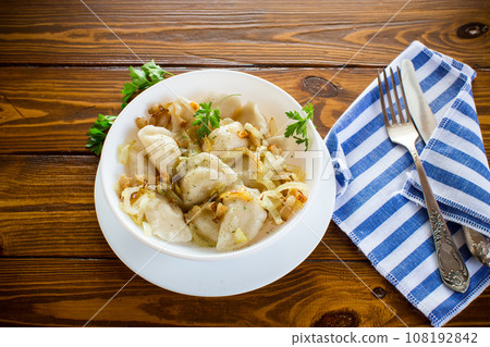 Ukrainian Vareniky or Pierogi stuffed with potato and mushrooms, served with fried onion. 108192842