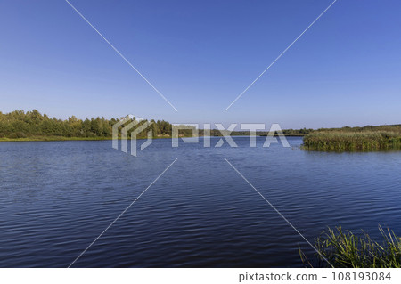 a wide river in sunny weather in early autumn 108193084