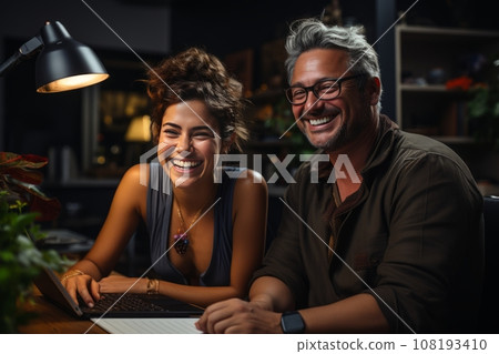 A man and a woman discuss a project in the evening in the office. business people meet in the office, analyze the results and formulate a strategy 108193410