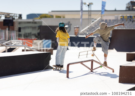 Skater preparing for a trick, bending low Skater preparing for a trick, bending low 108194251