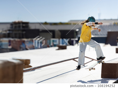 Skater young teen girl cruising on a flat platform Skater young teen girl cruising on a flat platform 108194252