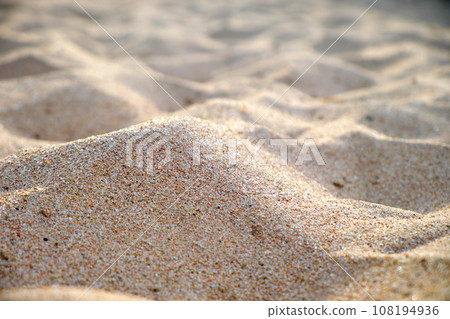 Close up of clean yellow sand surface covering seaside beach illuminated with day light. Travel and vacations concept 108194936