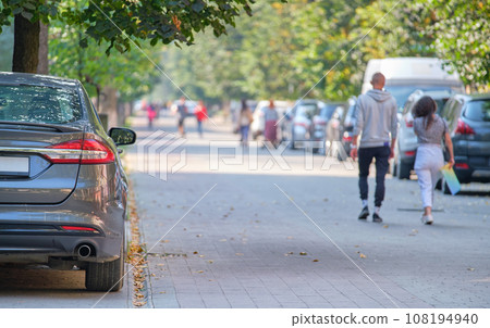Close up of a car parked illegally against traffic rules on pedestrian city street side. Close up of a car parked illegally against traffic rules on pedestrian city street side. 108194940
