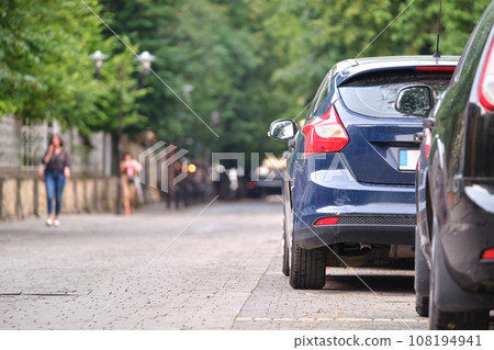 Close up of a car parked illegally against traffic rules on pedestrian city street side Close up of a car parked illegally against traffic rules on pedestrian city street side 108194941