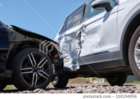 Cars crashed heavily in road accident after collision on city street. Road safety and insurance concept Cars crashed heavily in road accident after collision on city street. Road safety and insurance concept 108194956