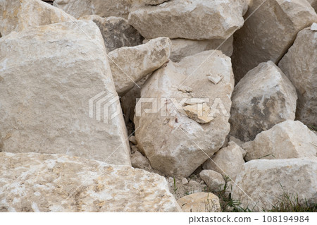 Big pile of large sand stones laying on the ground of construction site. 108194984