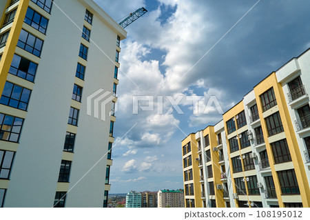 Architectural details of modern high apartment building facade with many windows and balconies 108195012