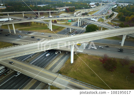 American freeway intersection with fast driving cars and trucks. View from above of USA transportation infrastructure 108195017
