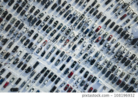 Aerial view of vehicle open market lot with many cars for sale parked and people customers walking in winter Aerial view of vehicle open market lot with many cars for sale parked and people customers walking in winter 108196932