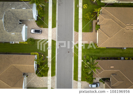 Aerial view of tightly located family houses in Florida closed suburban area. Real estate development in american suburbs 108196956