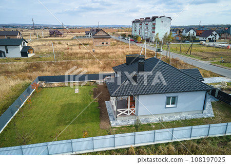 Aerial view of residential house with backyard in suburban rural area 108197025
