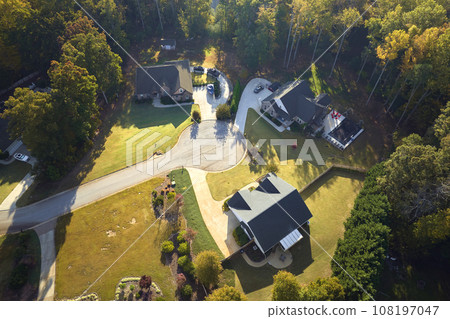 Aerial view of new family houses between yellow trees in South Carolina suburban area in fall season. Real estate development in american suburbs Aerial view of new family houses between yellow trees in South Carolina suburban area in fall season. Real estate development in american suburbs 108197047