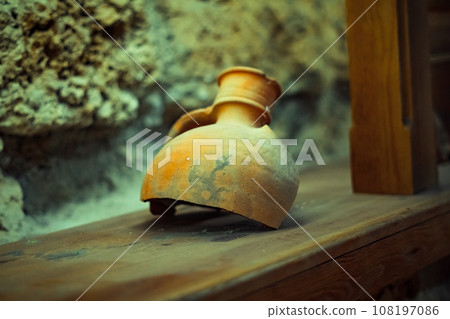 an old clay jug with a crack 108197086