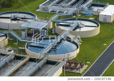 Aerial view of modern water cleaning facility at urban wastewater treatment plant. Purification process of removing undesirable chemicals, suspended solids and gases from contaminated liquid Aerial view of modern water cleaning facility at urban wastewater treatment plant. Purification process of removing undesirable chemicals, suspended solids and gases from contaminated liquid 108197146