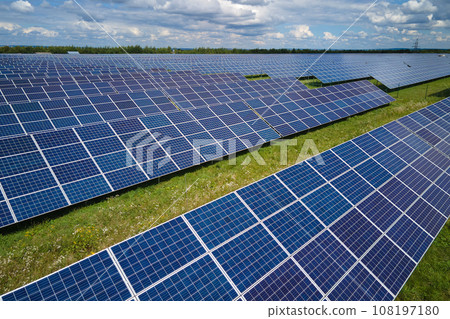 Aerial view of large sustainable electrical power plant with rows of solar photovoltaic panels for producing clean electric energy. Concept of renewable electricity with zero emission Aerial view of large sustainable electrical power plant with rows of solar photovoltaic panels for producing clean electric energy. Concept of renewable electricity with zero emission 108197180
