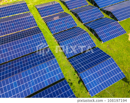 Aerial view of large sustainable electrical power plant with rows of solar photovoltaic panels for producing clean ecological electric energy. Renewable electricity with zero emission concept. 108197194