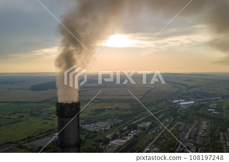 Aerial view of high chimney pipes with grey smoke from coal power plant. Production of electricity with fossil fuel. Aerial view of high chimney pipes with grey smoke from coal power plant. Production of electricity with fossil fuel. 108197248