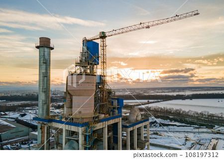 Aerial view of cement plant with high factory structure and tower crane at industrial production area. 108197312