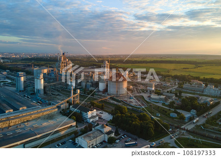 Aerial view of cement factory with high concrete plant structure and tower crane at industrial production area. Manufacture and global industry concept. 108197333