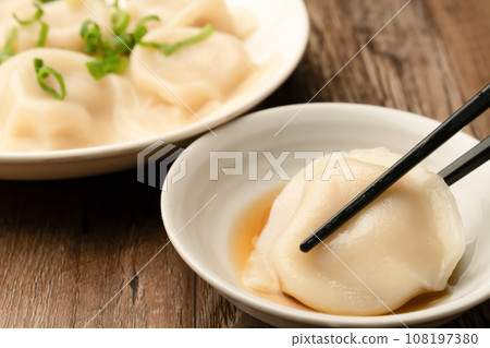 Boiled gyoza with chopsticks Boiled gyoza with chopsticks 108197380