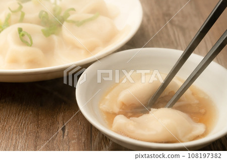 Boiled gyoza with chopsticks 108197382