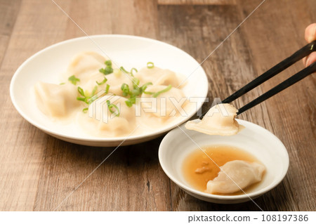 Boiled gyoza with chopsticks 108197386