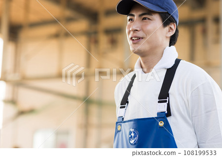 A young fisherman working at a fishing port A young fisherman working at a fishing port 108199533