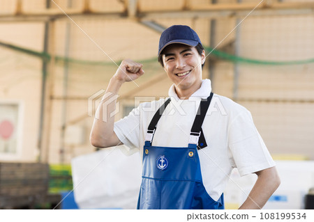 A young fisherman working at a fishing port A young fisherman working at a fishing port 108199534