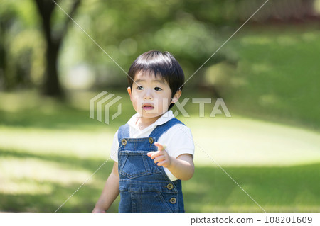 A boy playing in a park A boy playing in a park 108201609