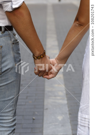 Man and woman holding by hands Man and woman holding by hands 108201743