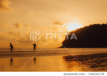 Layan Beach, Phuket, Thailand,Silhouette Asian man standing fishing at the sea as the sun sets, Layan Beach, Phuket, Thailand,Silhouette Asian man standing fishing at the sea as the sun sets, 108203176
