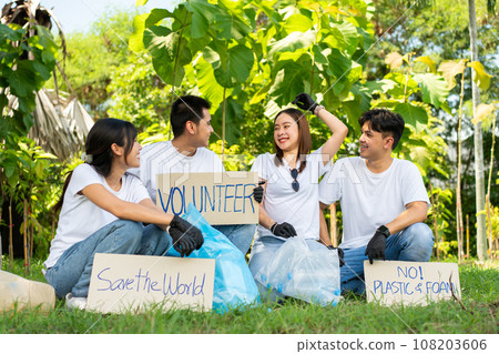 Happy young Asian students diverse volunteers hold a campaign sign for cleaning in the park, The concept of environmental conservation on world environment day, recycling, charity for sustainability. Happy young Asian students diverse volunteers hold a campaign sign for cleaning in the park, The concept of environmental conservation on world environment day, recycling, charity for sustainability. 108203606