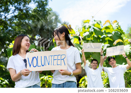 Happy young Asian students diverse volunteers hold a campaign sign for cleaning in the park, The concept of environmental conservation on world environment day, recycling, charity for sustainability. Happy young Asian students diverse volunteers hold a campaign sign for cleaning in the park, The concept of environmental conservation on world environment day, recycling, charity for sustainability. 108203609