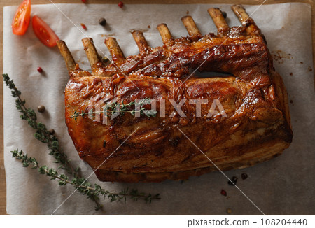 Delicious roasted ribs served on wooden table, flat lay 108204440