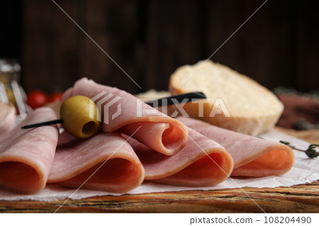Slices of tasty ham with olive on table, closeup 108204490