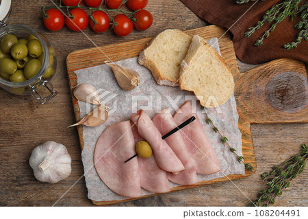 Tasty ham served on wooden table, flat lay Tasty ham served on wooden table, flat lay 108204491