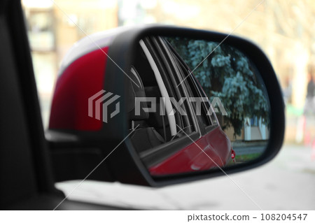 Side rear view mirror of modern car outdoors, closeup Side rear view mirror of modern car outdoors, closeup 108204547
